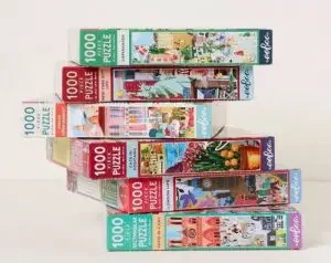 Stack of wanderlust jigsaw puzzles