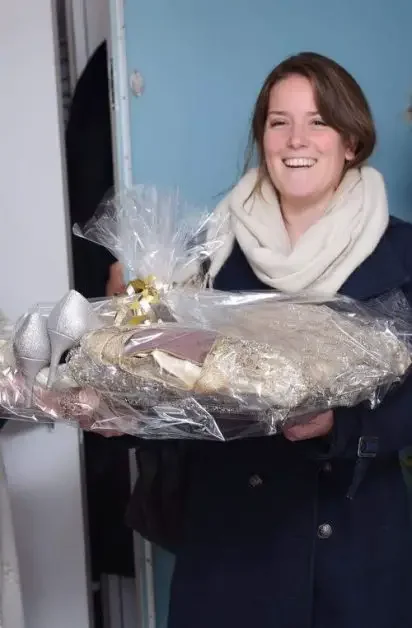 A woman walking in with a gift basket