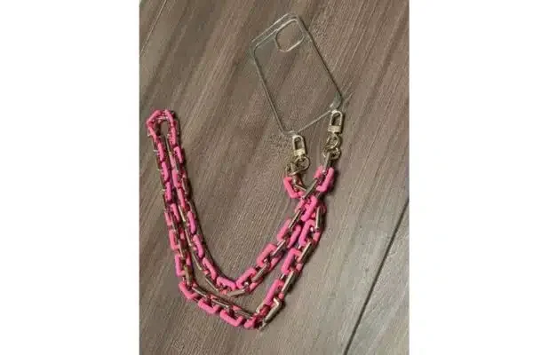 A clear phone cover with a pink chain