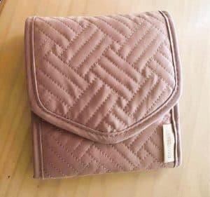 A pink wallet shaped jewelry organizer for travelers