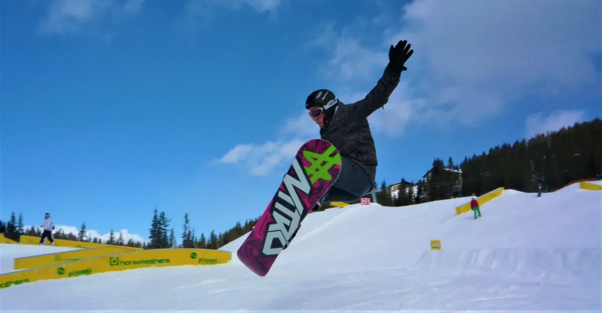 A snowboarder jumping in the air
