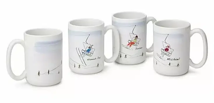 Four mugs with drawings of people in ski lifts