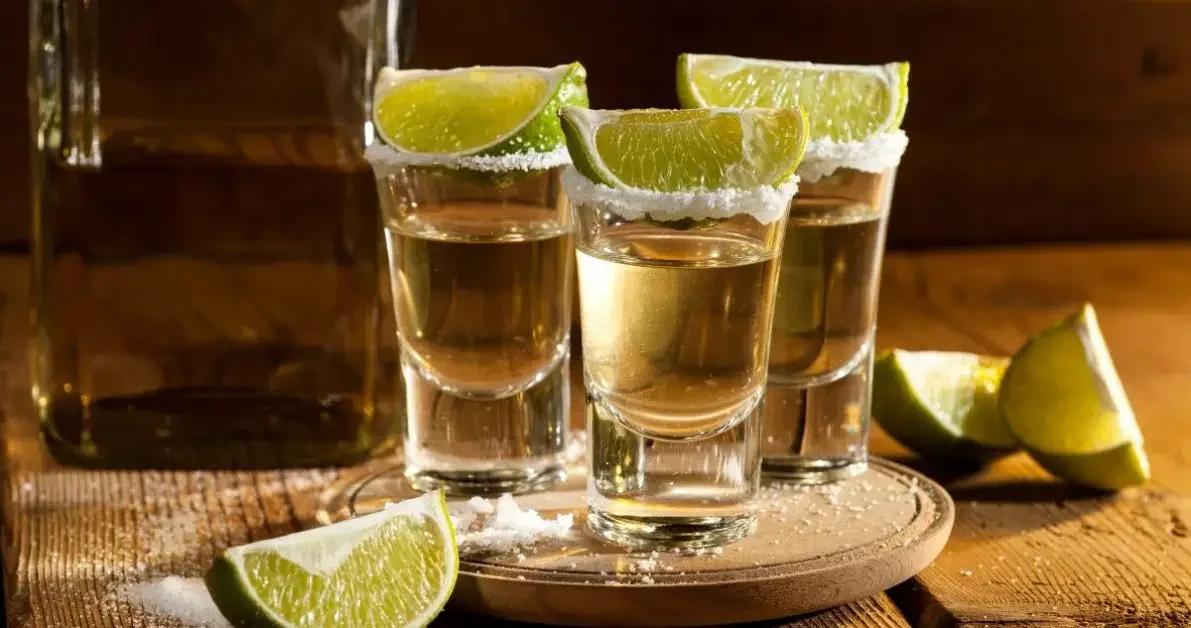 Three shots of tequila with lime and salt