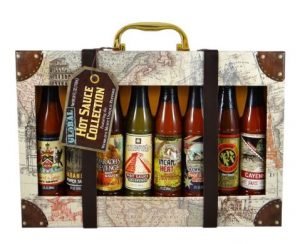 A suitcase shaped box with various hot sauces from around the world