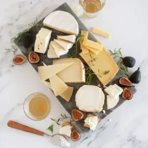 A plate filled with different French cheese and pairings