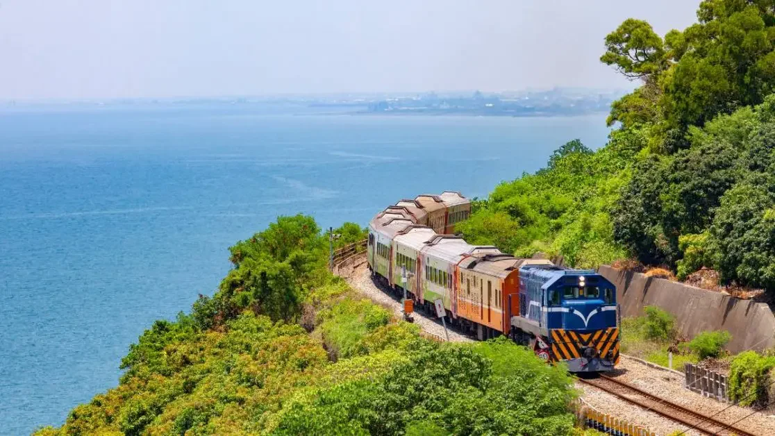 Photo of a train on a track near the ocean