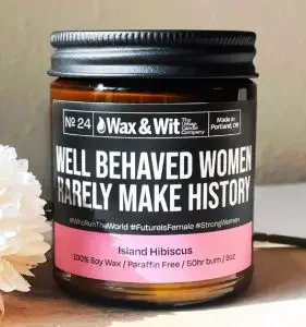 Candle with a funny label that says "well behaved women rarely make history"