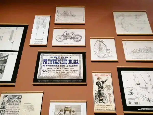 A wall with prints of old bicycles and other forms of transportation