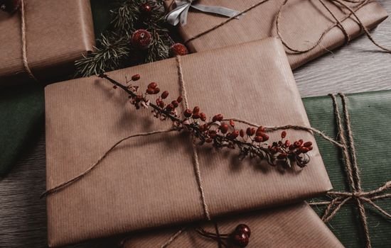 Gifts wrapped in kraft paper with a string and natural decorations