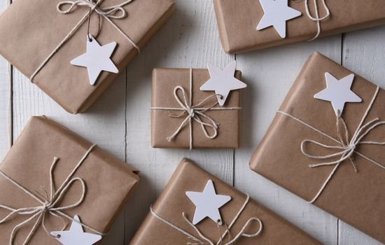 gifts wrapped in kraft paper with stings and decorations