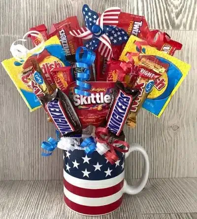 A mug with the Flag of America and snacks sticking out of it like a bouquet