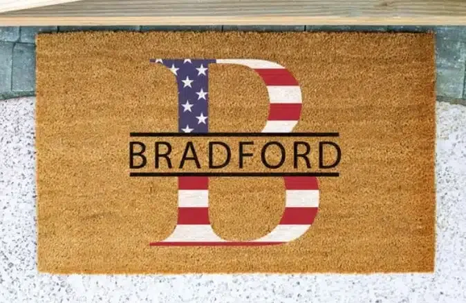 A doormat with a B in the color of the flag of the US and Bradford written