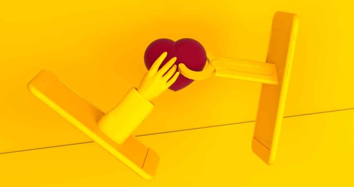 Two icons of yellow cell phones that are holding a red heart in the middle