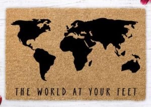 Doormat with "The world at your feet" and an image of the world map