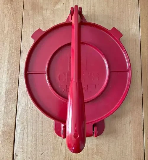 A red tortilla press from Mexico
