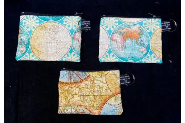 Three small coin purses with maps