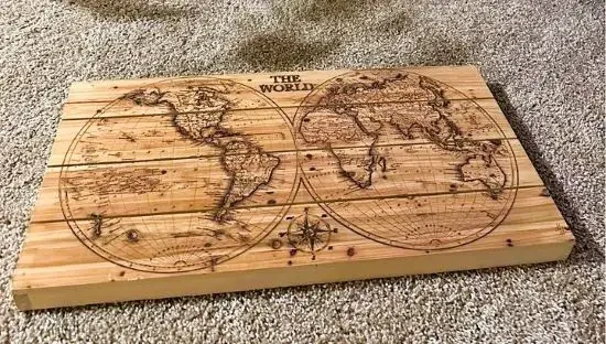 A wooden cutting board with the globe etched on to it