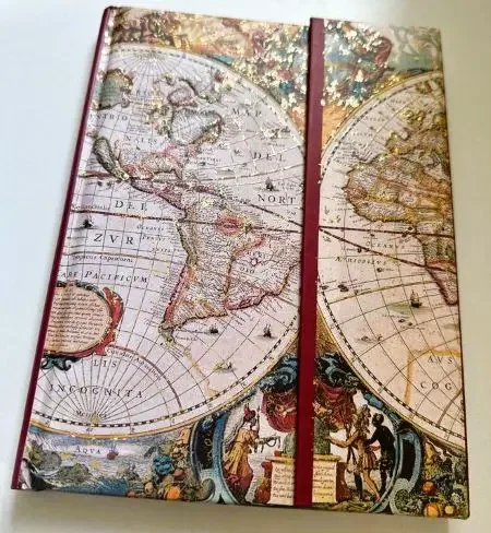 A notebook with a cover the globe