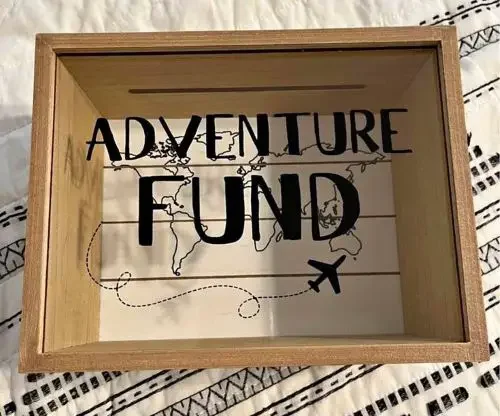 A piggy bank with the text "adventure fund"