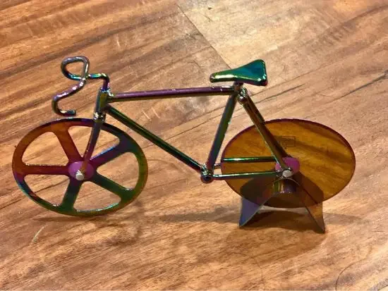 A pizza cutter in the shape of a bicycle
