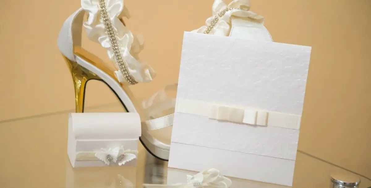 A wedding shoe and and a wedding card with other ornaments