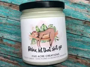 A soy wax candle with a label "Relax, let that sh*t go"