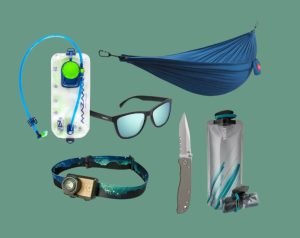 Outdoor gear such as sunglasses, hammock, knife, water bottle and head torch