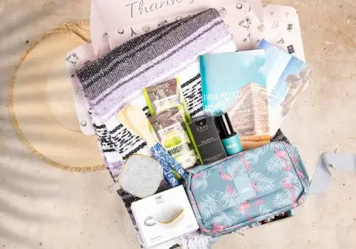 A gift box with items in the sand