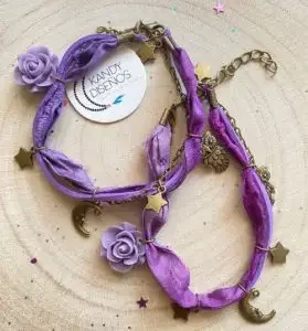 A bracelet made from silk sari with moon and star charms made in Ibiza