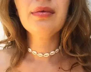 Woman wearing a choker necklace made from sea shells