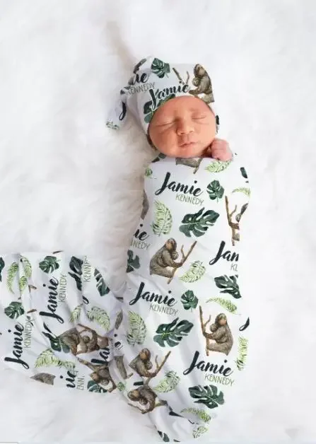 A baby wrapped in sloth-themed cloth