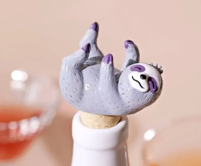 A wine stopper with a sloth