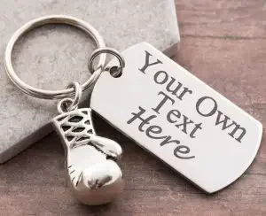 A keychain with a boxing glove and a personalized text