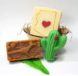 An Arizona gift of three soap bars shaped like a cactus, the map of Arizona, and a roadrunner