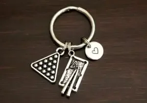 A keychain with billiard balls and cues