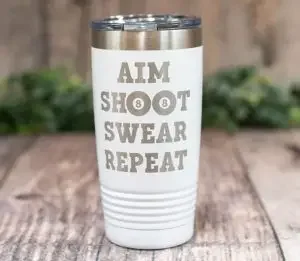 A white tumbler for pool players with "aim, shoot, swear, repeat"