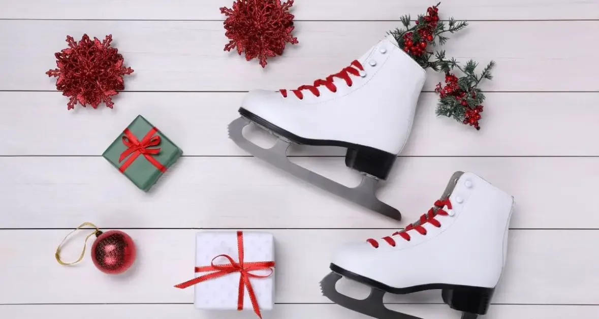 A pair of figure skates with Christmas ornaments and gifts