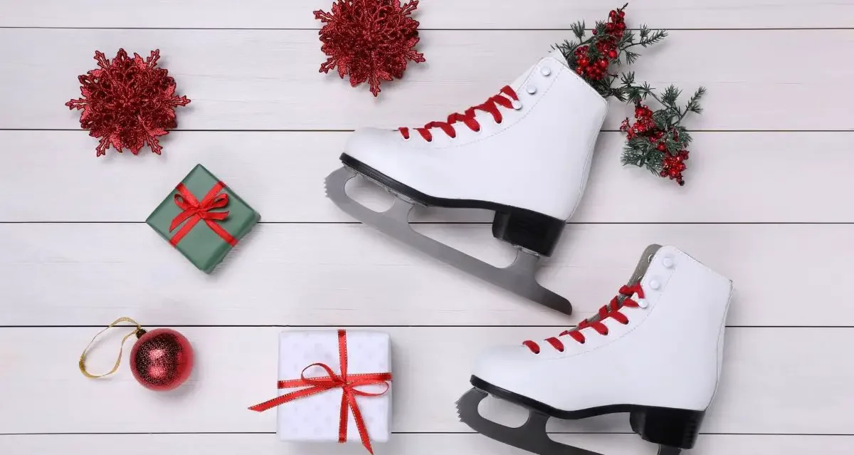 A pair of figure skates with Christmas ornaments and gifts
