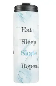 A tumbler with the text "eat, sleep, skate, repeat"