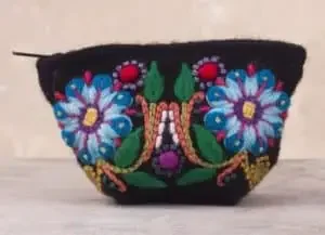 A handmade coin purde with a floral print from Peru