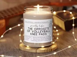 Candle with a funny label that says "smells like the opposite of volleyball knee pads"