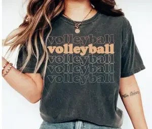 A woman wearing a black shirt with volleyball five times