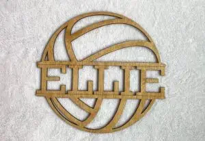A wooden wall decoration in the shape of a volleyball and with a name