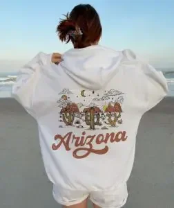 Woman wearing a white hoodie with "Arizona"