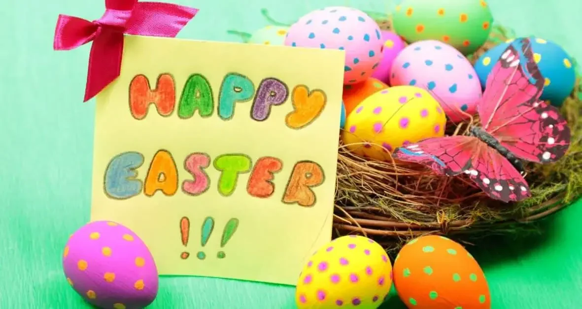 A sign with Happy Easter and a Easter basket filled with eggs