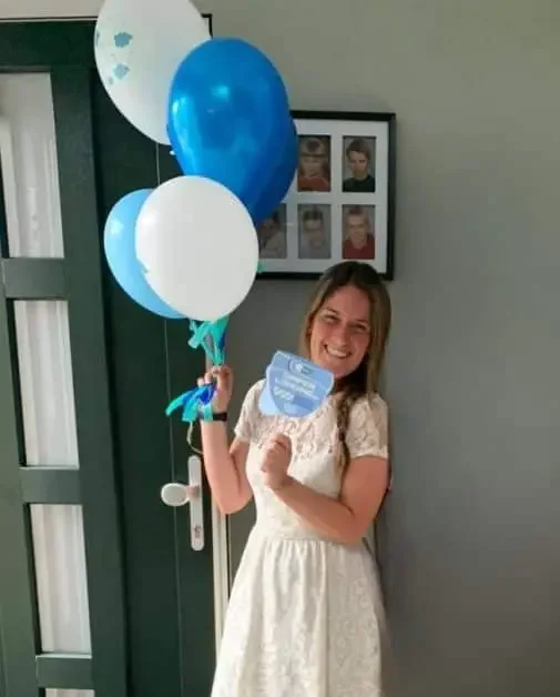 A photo of a woman holding balloons