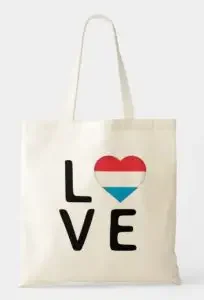 A tote bag with the word "love" and the "o" as a heart with the colors of the flag of Luxembourg