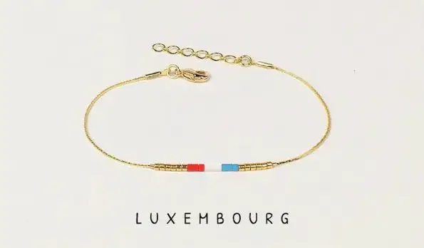 A golden bracelet with beads in the color of the flag of Luxembourg